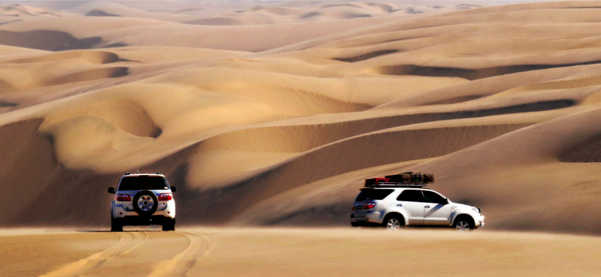 sand desert dunes two Toyota fortuners wide angel