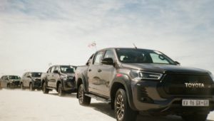 Toyota Hilux GR-S tackles the sand next to unique competition